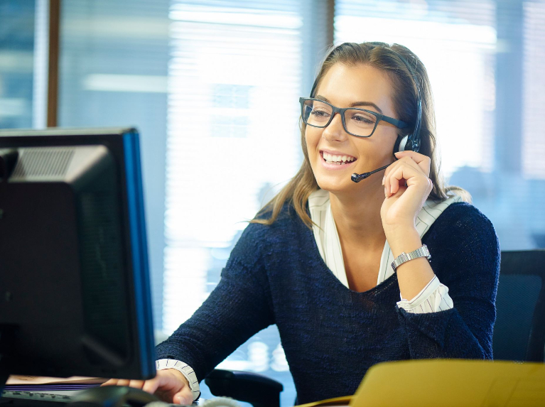 Woman answering customer calls at a contact centre